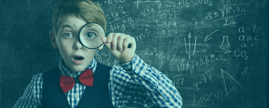 Young-Boy-in-Front-of-School-Blackboard